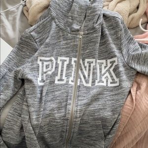 a grey zipper up from pink